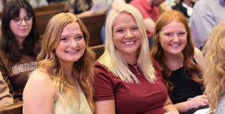 three people smiling at honors convocation