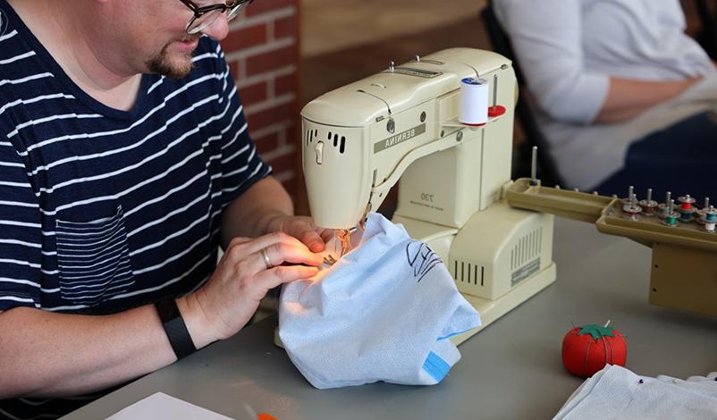 a man using a sewing machine
